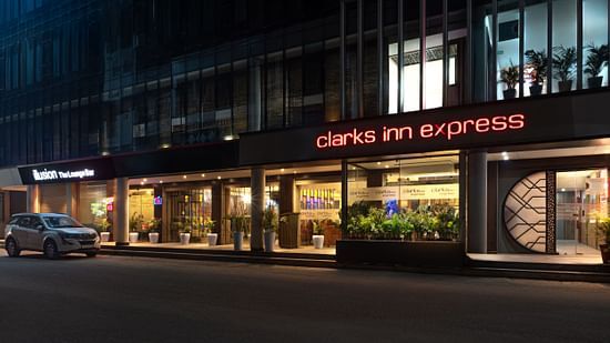  The exterior of  Clark Inn Express hotel with bright signage, showcasing its modern architecture and inviting entrance at night - Clarks Inn Express, Near Jammu Bari Brahmana Railway Station