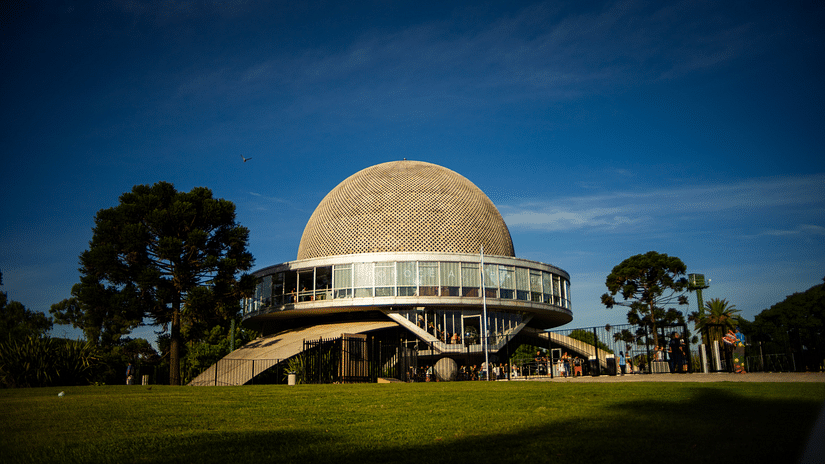 An overview of a planetarium surrounded by a park.