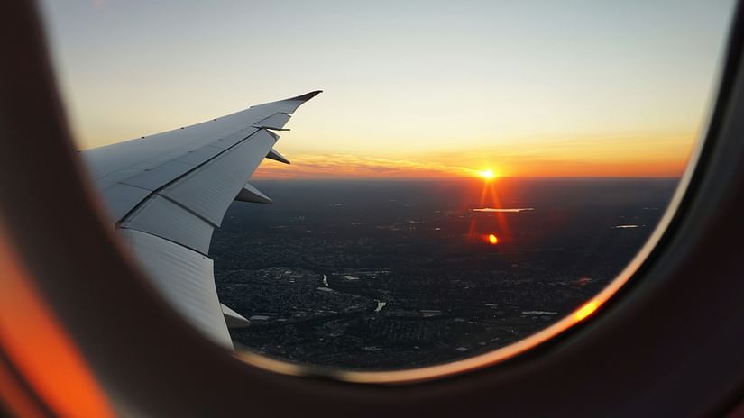 A sunset seen through the window of a aeroplane