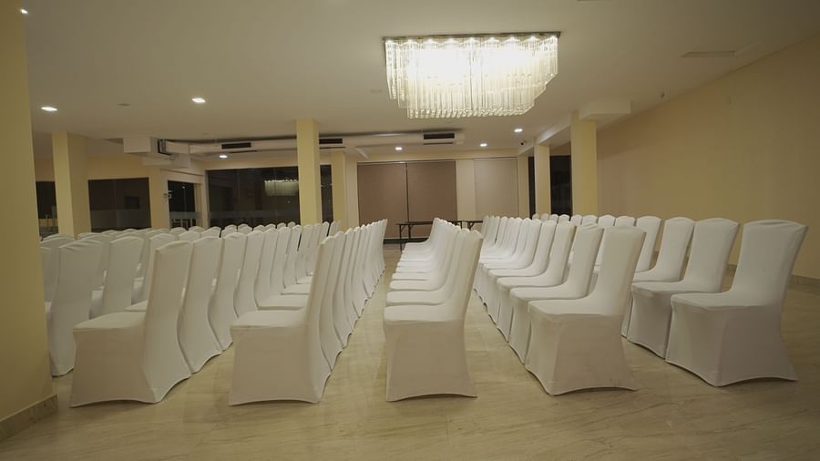 Chairs arranged perfectly under warm lighting in the spacious Apollo Banquet Hall at Citrus Classic Resorts and Spa Mahabalipuram ECR