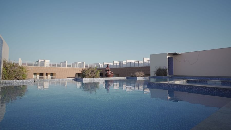 Swimming pool at Citrus Classic Resorts and Spa Mahabalipuram ECR reflecting the calm surrounding  under clear sky