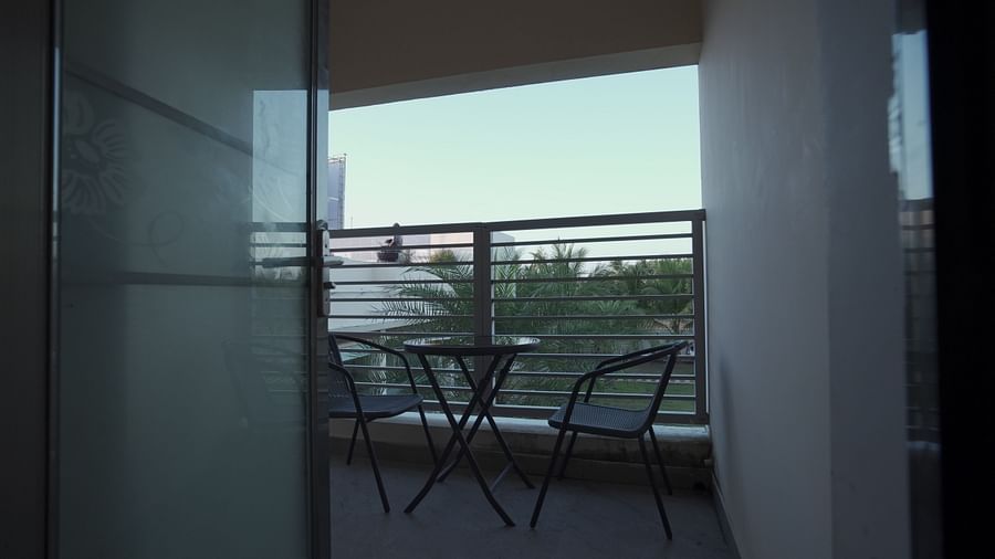 Balcony of Premium Room at Citrus Classic Resorts and Spa Mahabalipuram ECR featuring a couple of chairs facing each other and a circular coffee table in the middle with a serene outdoor view