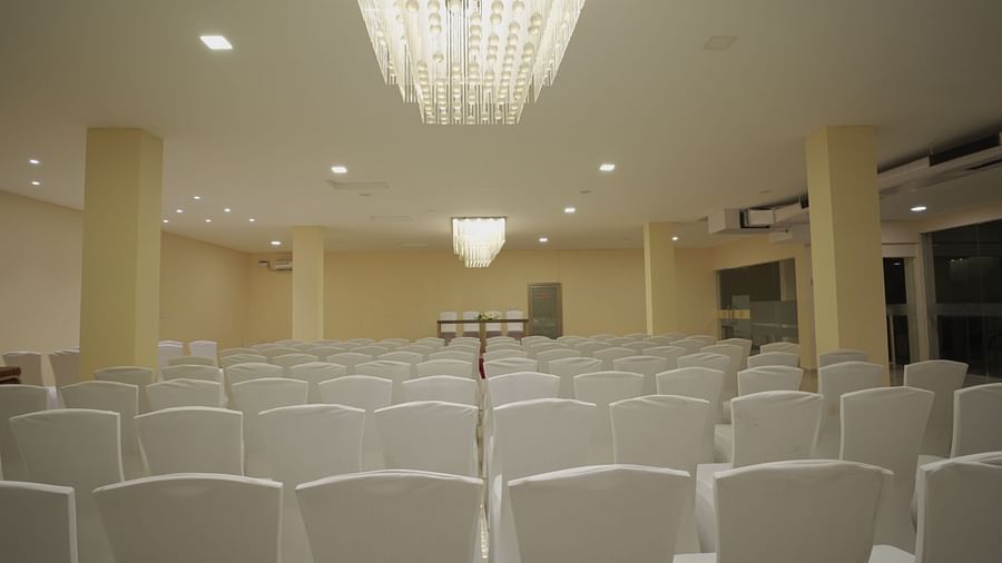 Chairs facing the stage at Apollo Banquet Hall, Citrus Classic Resorts and Spa Mahabalipuram ECR under warm lighting from the ceiling