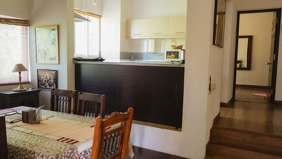 Dining table with steps leading to the kitchen at El Benito Goa