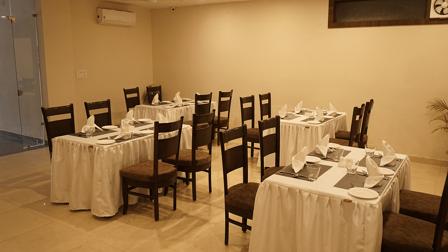 Image of the cafe at Five Elements Hotels, Haridwar, showcasing neatly arranged tables and chairs