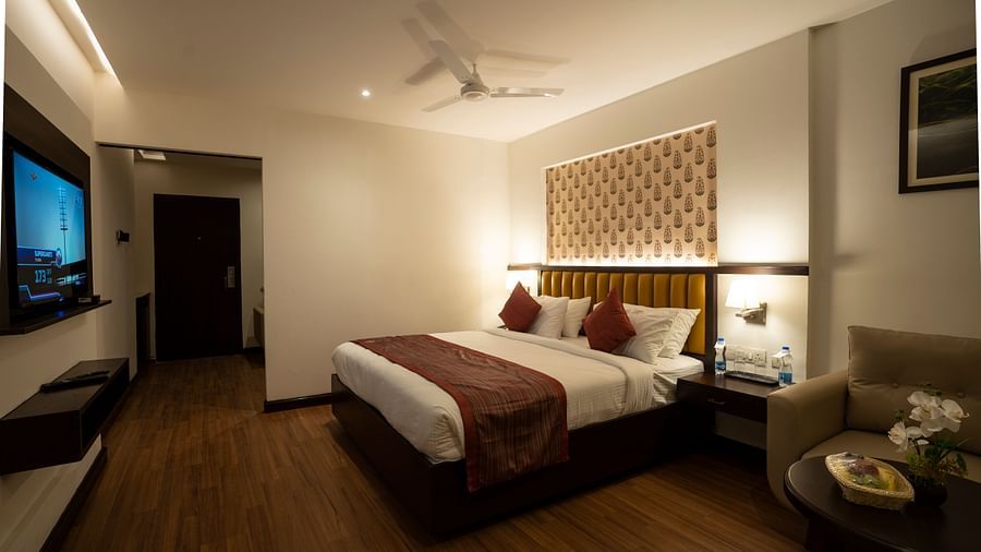 Superior room with a double bed and a television at Grand Continent, Secunderabad
