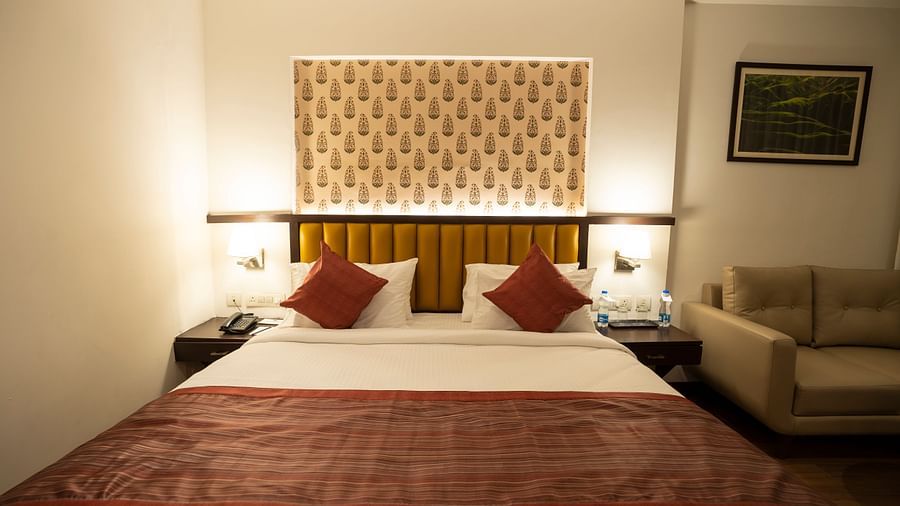 Superior room with a double bed and a sofa at Grand Continent, Secunderabad