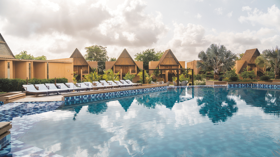 An overview of Jagira Ananta Elite, Gir with rooms in the distance and the swimming pool in the foreground