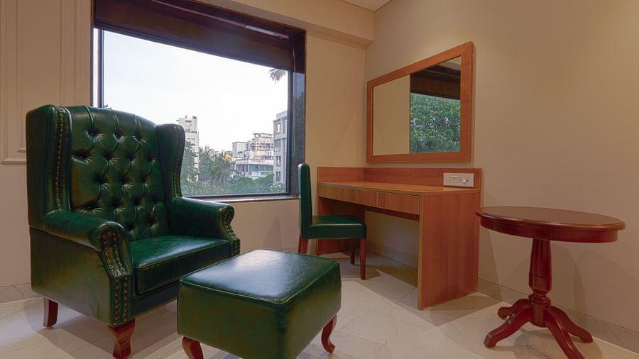 High Back Chairs and a table in a room with a window