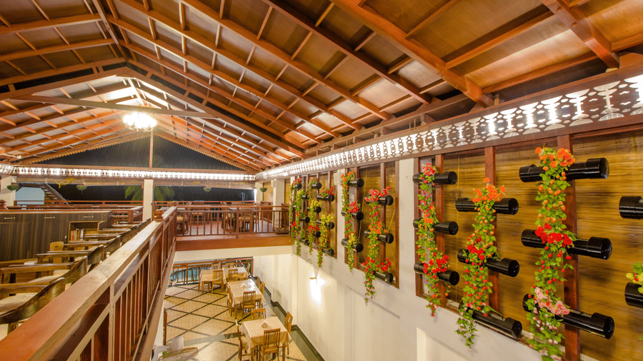 Wine rack on one side and seating arrangements on the other at Organikhaa, one of the best restaurants in Neil Island at Symphony Summer Sand Beach Resort And Spa, Neil island