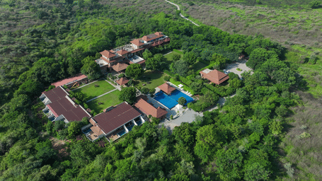 A birds' eye view of the Anandam Jungle Retreat Resort, Udaipur, surrounded by lush greenery on all the 4 sides.