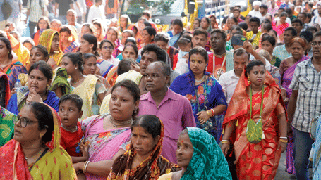 A parade of devotees with colourful attire.