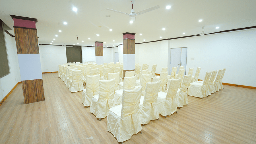 A large, empty banquet hall with rows of chairs set up on a wooden floor | DLS Hotel Shiva Sanctuary & Spa, Dharamshala
