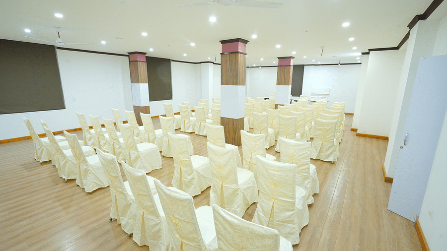 A large banquet hall with rows of chairs set up for a large gathering | DLS Hotel Shiva Sanctuary & Spa, Dharamshala