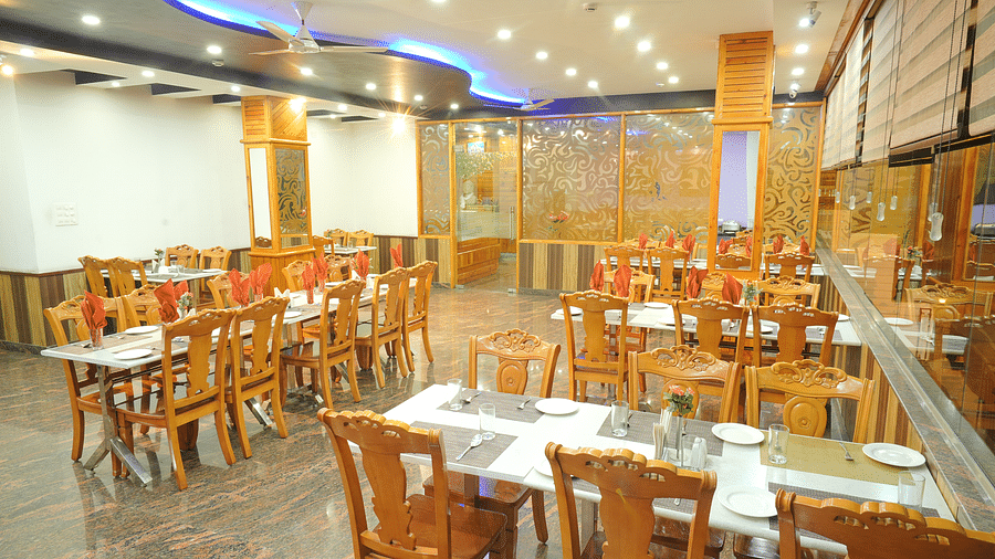 A close up shot of the restaurant with different table and chairs | DLS Hotel Shiva Sanctuary & Spa, Dharamshala
