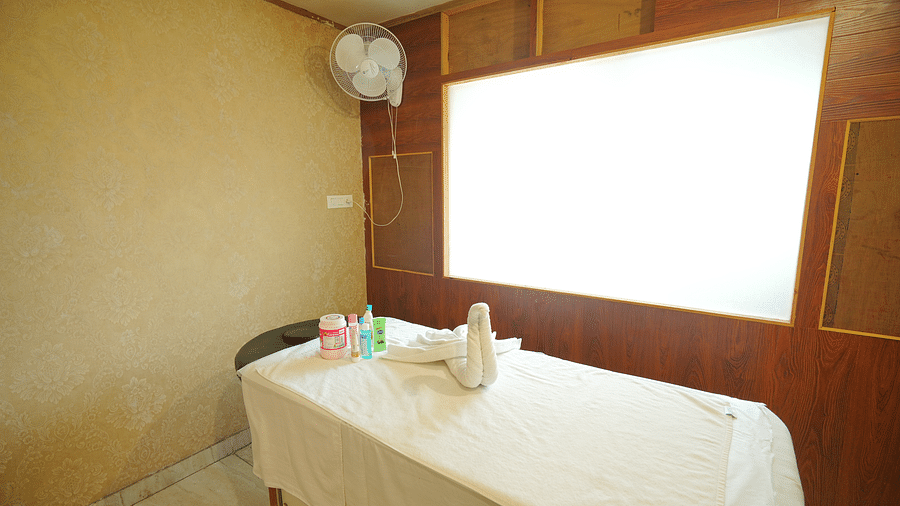 A spa room with a massage table made up with fresh linens and a decorative towel swan | DLS Hotel Shiva Sanctuary & Spa, Dharamshala