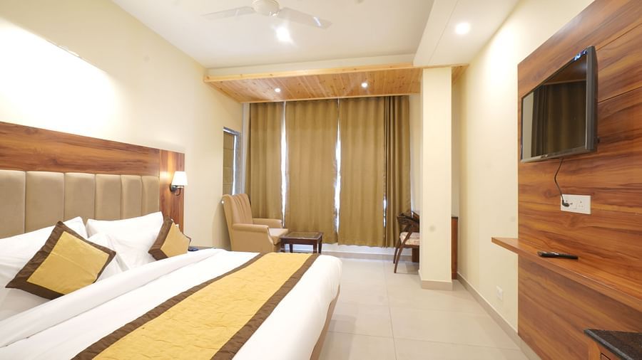 A large bed in Deluxe Room at DLS Oak Bush, Musssoorie.