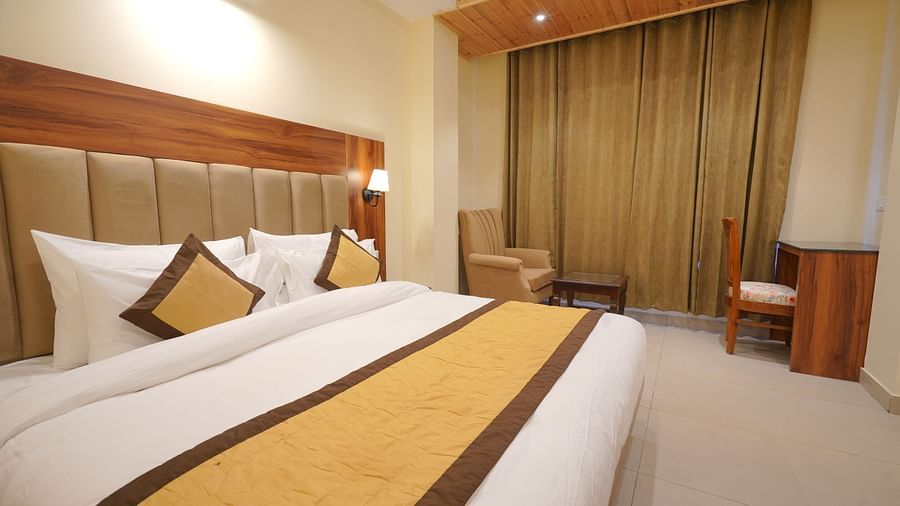 A large bed in Premium Room at DLS Oak Bush, Musssoorie.