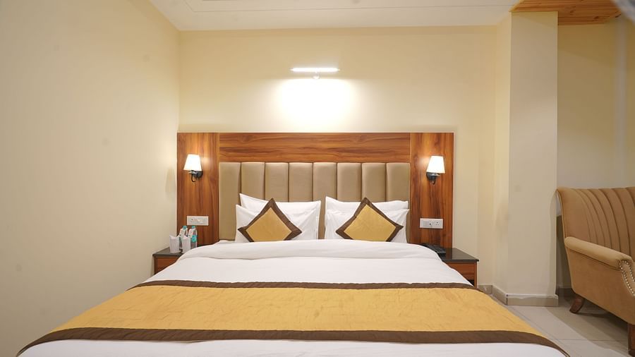 A large bed in Premium Room at DLS Oak Bush, Musssoorie.