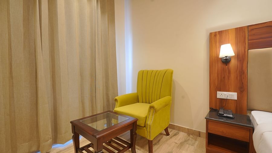 A sofa in front of the table at Premium Room at DLS Oak Bush, Musssoorie.