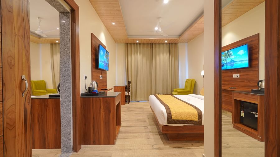 Entrance to Premium Room with a view of a TV in front of a large bed at DLS Oak Bush, Musssoorie.
