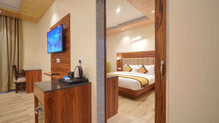View of the bed from the living room in Premium Room at DLS Oak Bush, Musssoorie. 