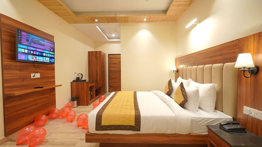 A large bed in Deluxe Room at DLS Oak Bush, Musssoorie.