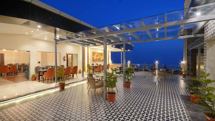Rooftop dining area during the evening at DLS Oak Bush, Mussoorie.