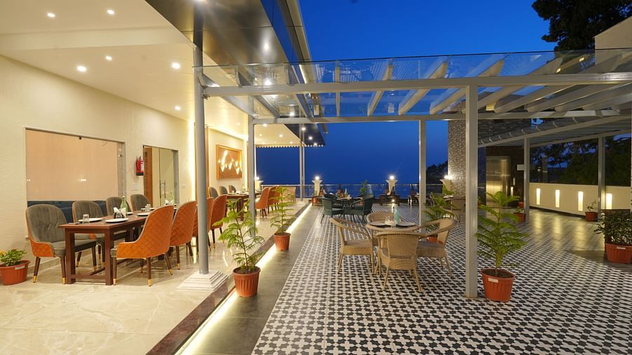 Rooftop dining area during the evening at DLS Oak Bush, Mussoorie.