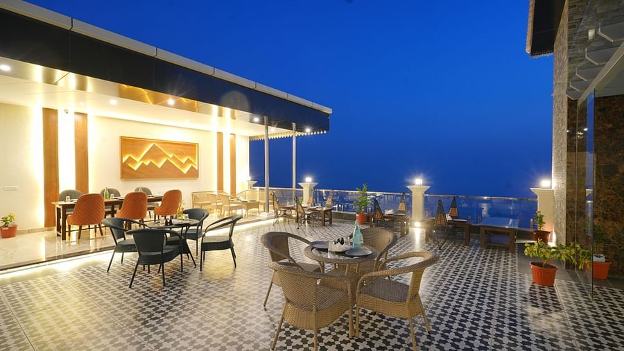 Rooftop dining area during the evening at DLS Oak Bush, Mussoorie.