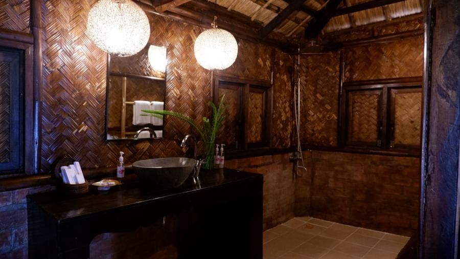 Spacious vanity area with wooden textures and warm lighting at Flower Island Resort.
