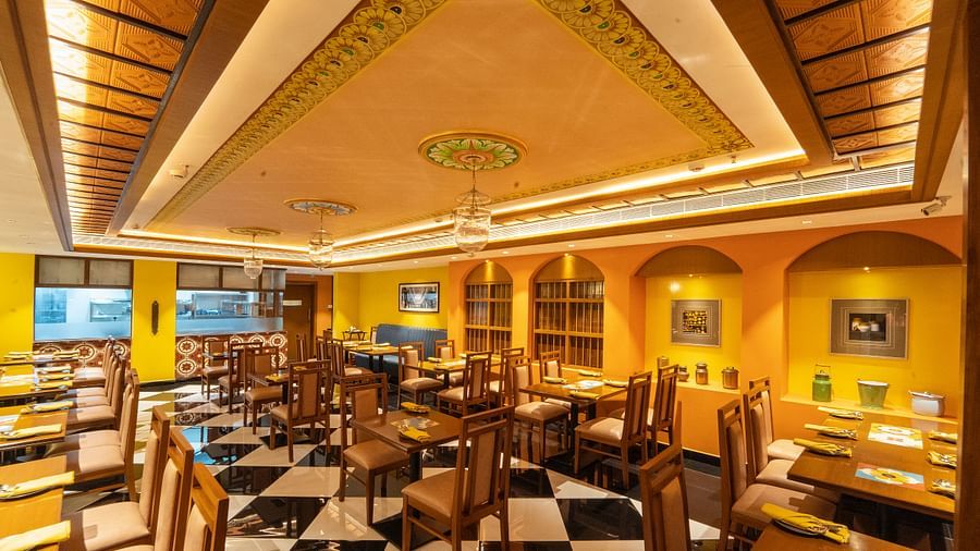 image of the chettinad stories with well defined seating arrangements for dining at hotel aadithya, chennai
