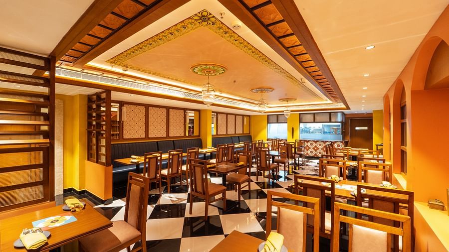 full view image of the dining area of the chettinad stories at hotel aadithya