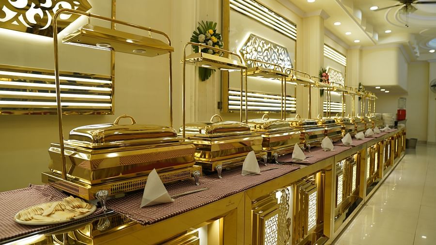 A photograph of a banquet hall in Roorkee featuring a chandelier and a buffet setup - Motel Divine International, Roorkee