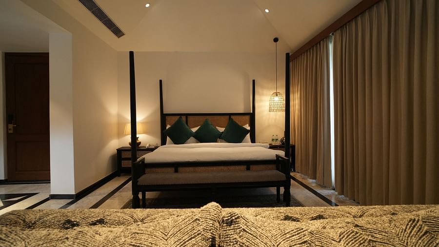 Front view of a room with a bed and window on the side at Surpura Bagh.