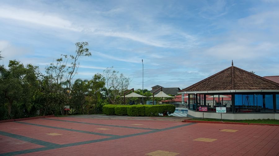Tiled Floor with a house and greenery in the background | Woodstock Resorts, Coorg