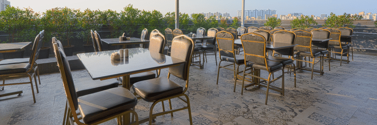 A restaurant at the rooftop where many tables and chairs are placed -  Magnus Fortune House, Magarpatta