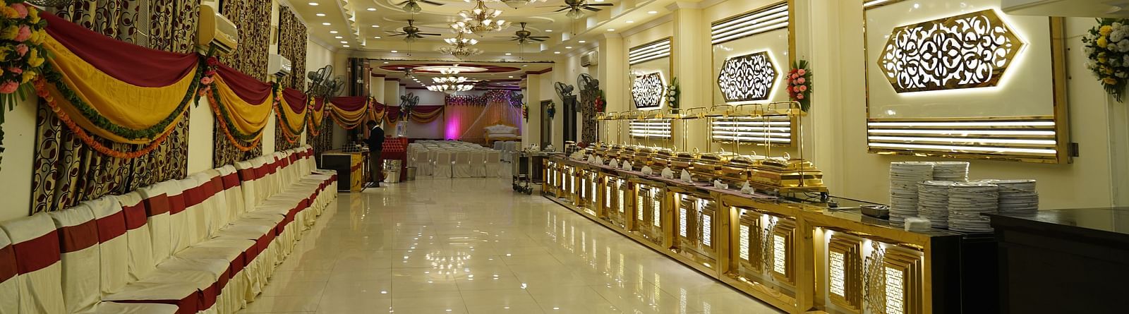 A photograph of a banquet hall in Roorkee featuring a chandelier and a buffet setup - Motel Divine International, Roorkee
