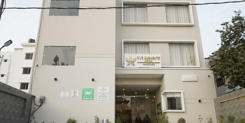 Facade of Five Elements Hotels, Haridwar, featuring the entrance pathway leading to the hotel