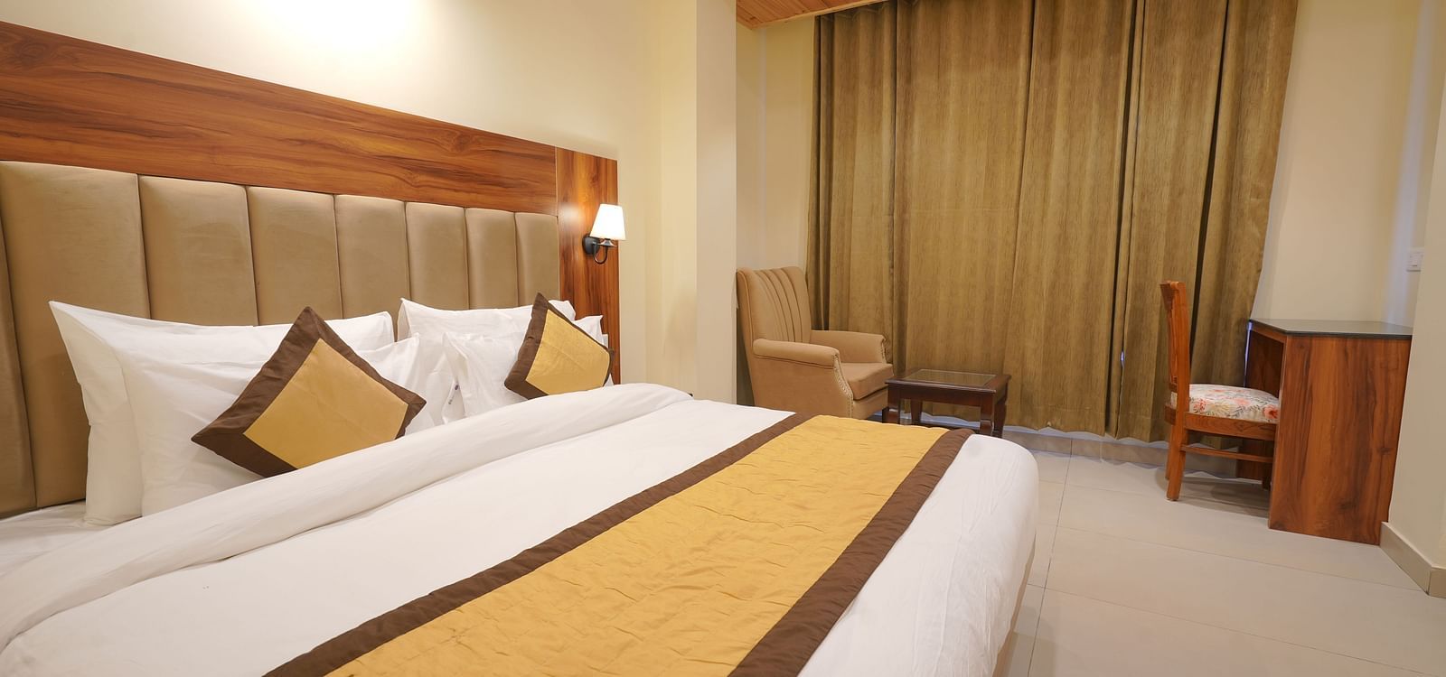 A large bed in Premium Room at DLS Oak Bush, Musssoorie.