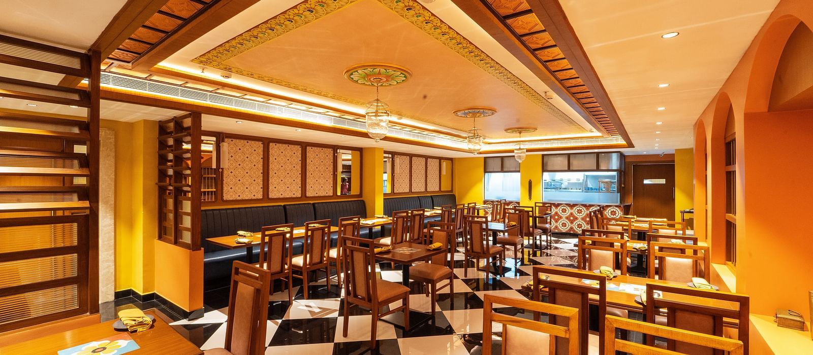full view image of the dining area of the chettinad stories at hotel aadithya