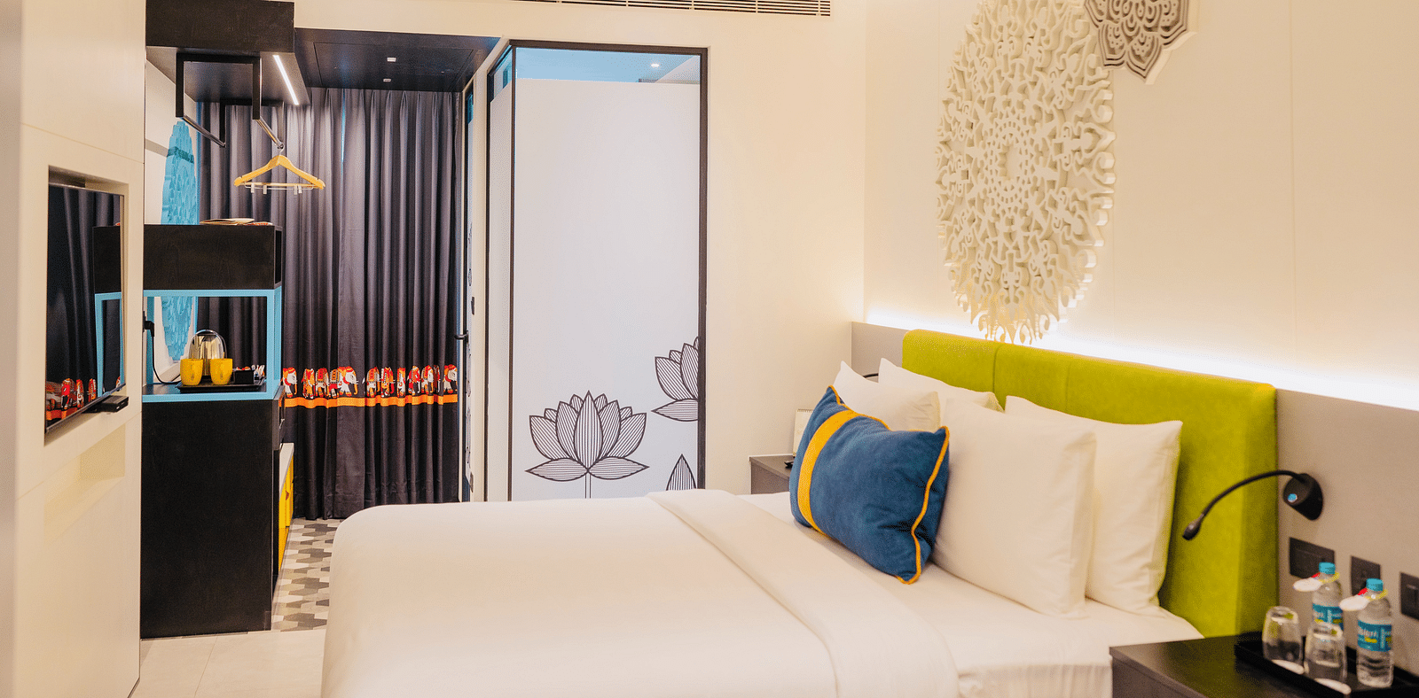 side view of a bedroom with tea and coffee maker at Zibe Luxe Kakinada by GRT Hotels