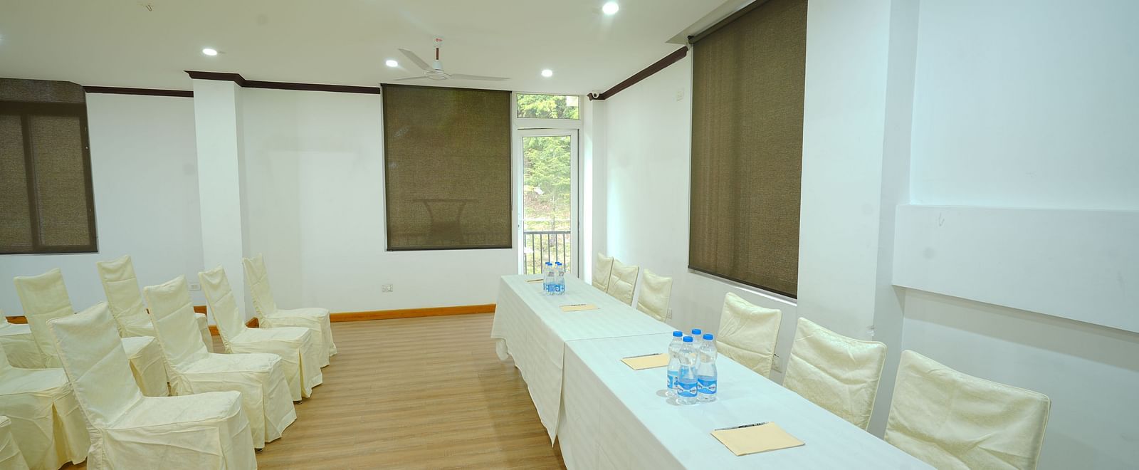 A large conference room with a long table and chairs set up for a meeting | DLS Hotel Shiva Sanctuary & Spa, Dharamshala