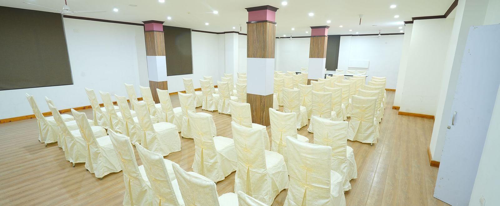 A large banquet hall with rows of chairs set up for a large gathering | DLS Hotel Shiva Sanctuary & Spa, Dharamshala