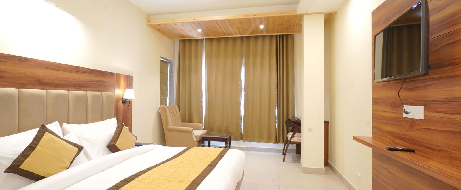 A large bed in Deluxe Room at DLS Oak Bush, Musssoorie.