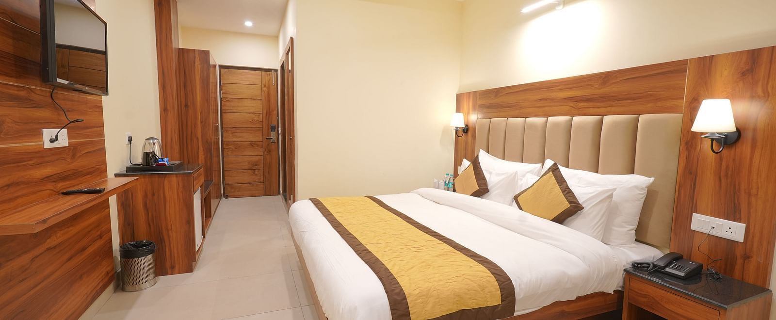 A large TV in front of the bed in Premium Room at DLS Oak Bush, Musssoorie.