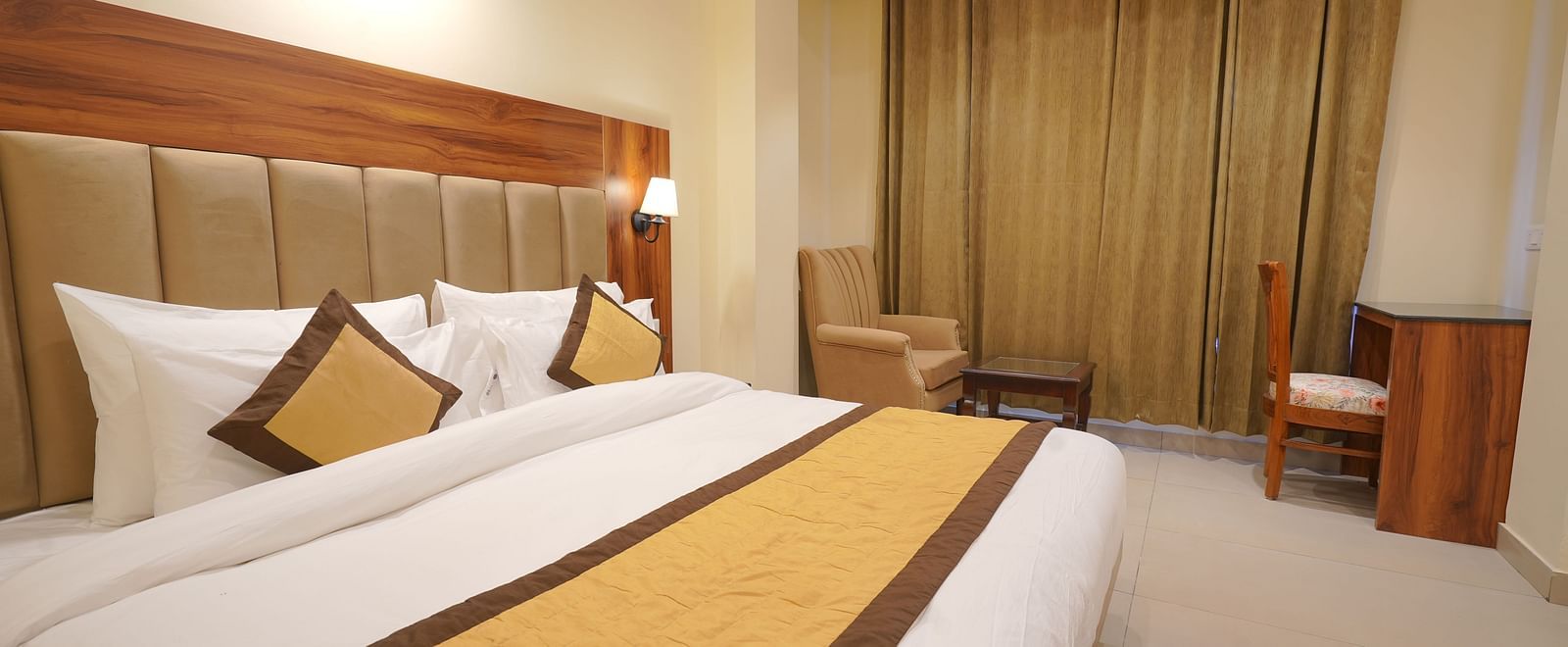 A large bed in Premium Room at DLS Oak Bush, Musssoorie.