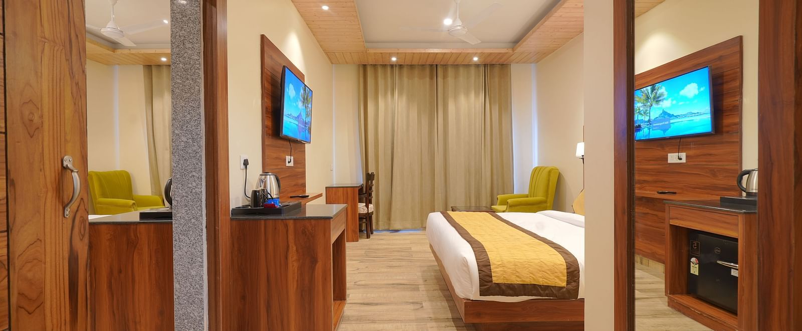 Entrance to Premium Room with a view of a TV in front of a large bed at DLS Oak Bush, Musssoorie.