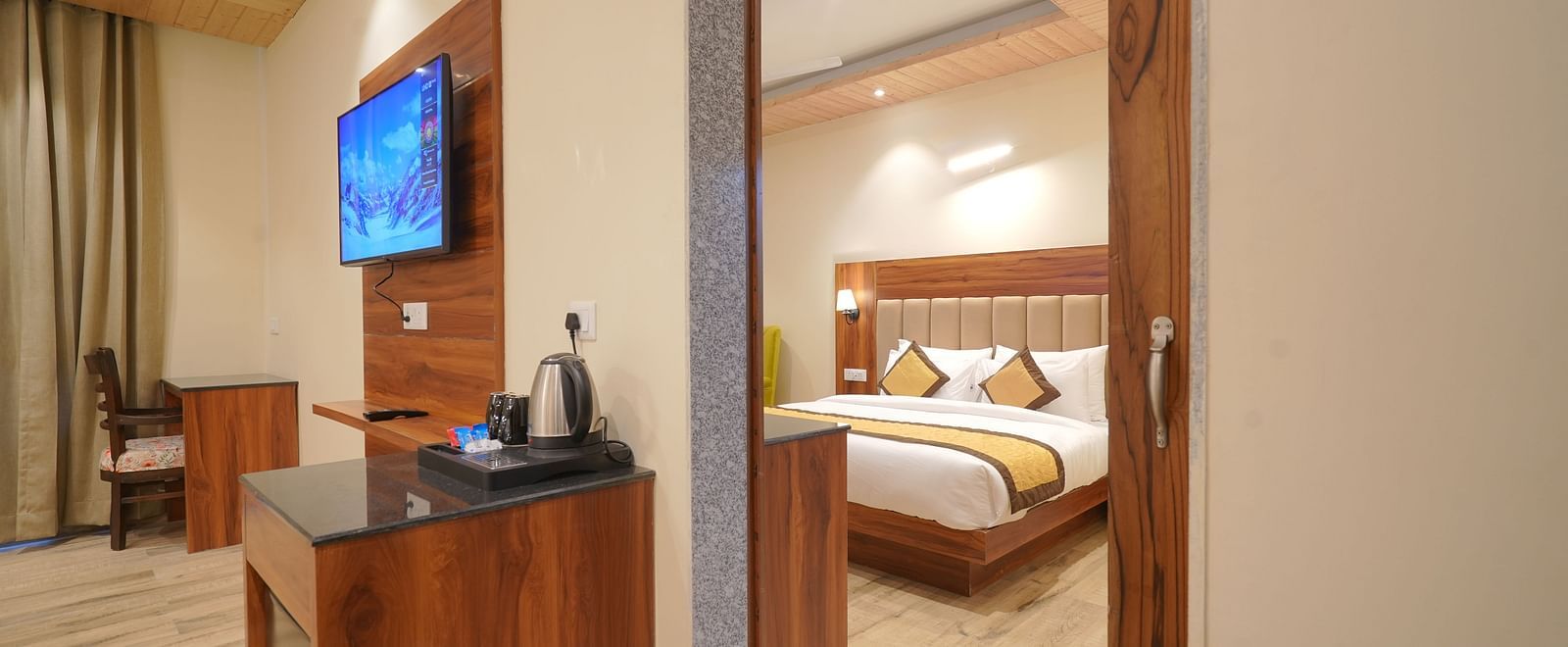 View of the bed from the living room in Premium Room at DLS Oak Bush, Musssoorie. 