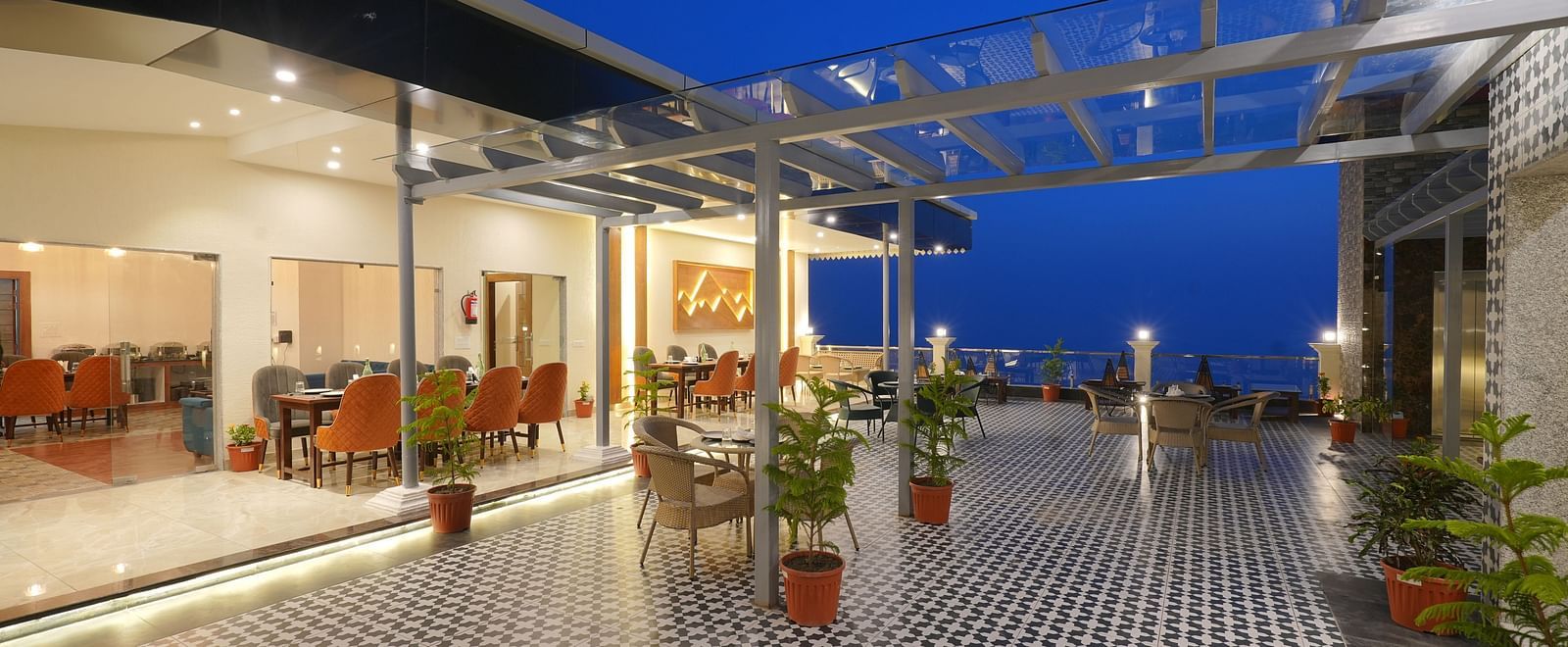 Rooftop dining area during the evening at DLS Oak Bush, Mussoorie.